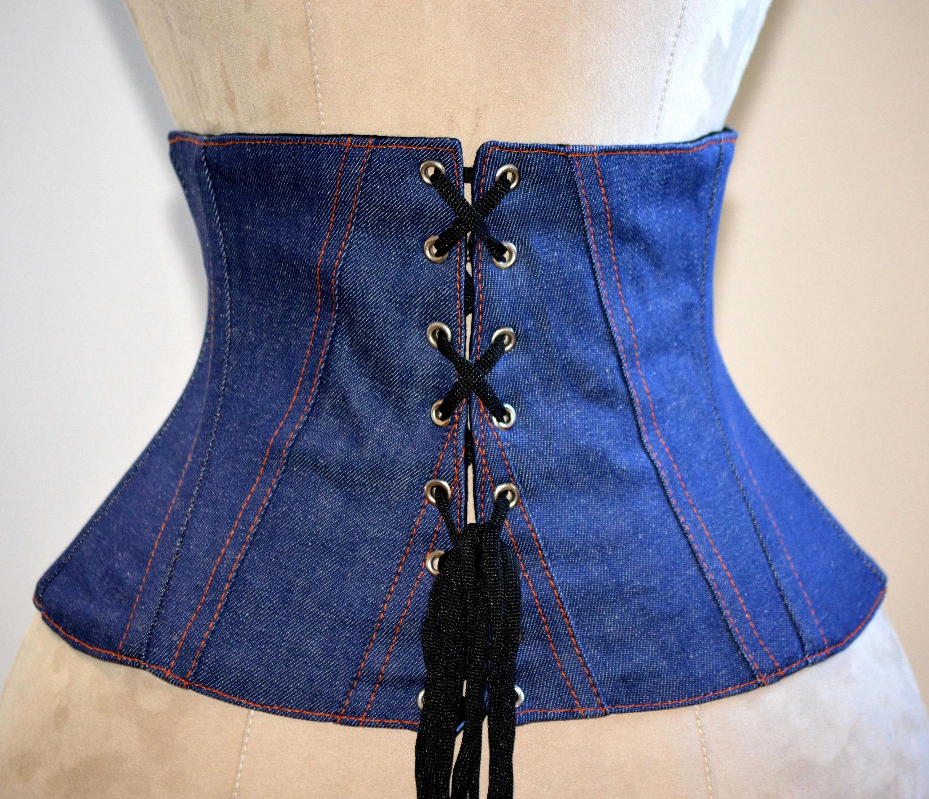 Trendy waspie belt corset from denim. Waist training fitness edition corset belt with laces in front, trendy summer corset